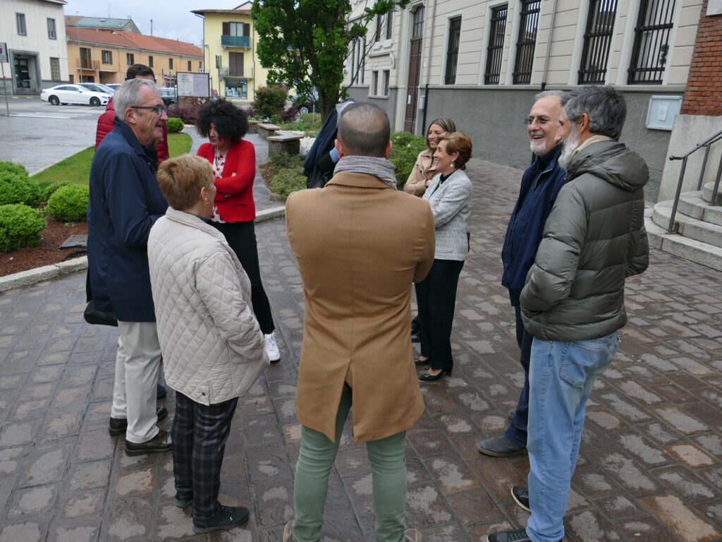 a group of people standing around each other